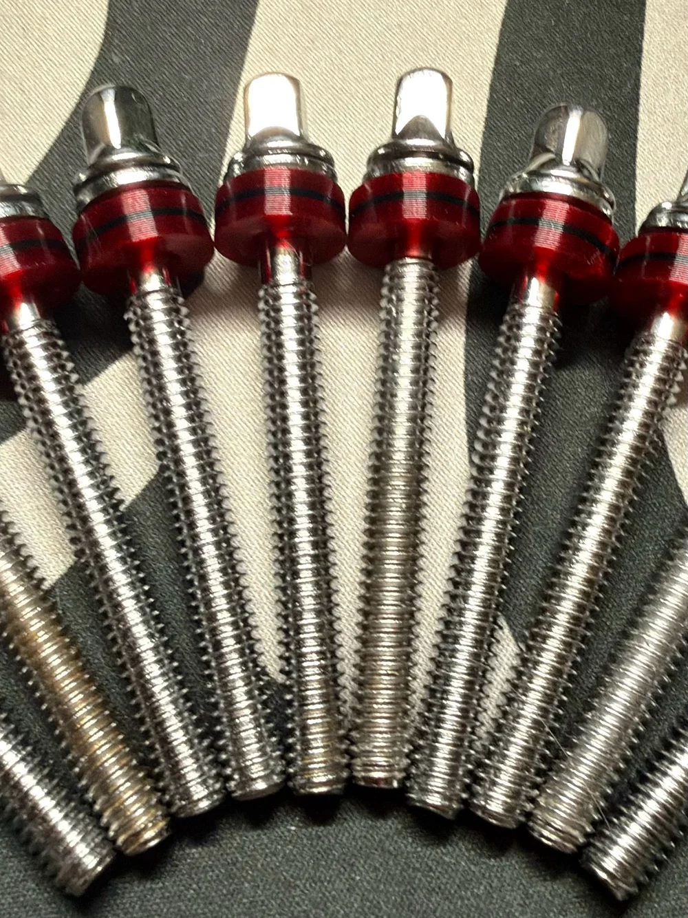 Red Kelley Drums washers with a black center accent on chrome tension rods